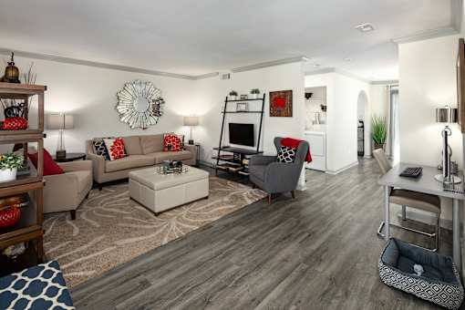 A living room with a grey couch and a white coffee table.