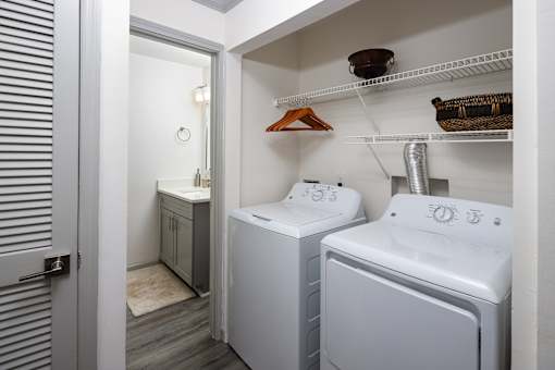 A small bathroom with a washer and dryer.