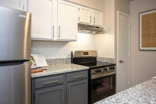 A kitchen with a stove and refrigerator.