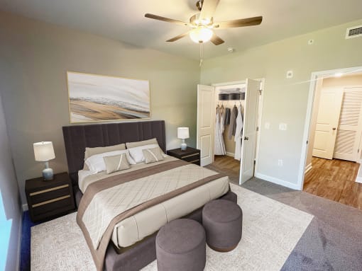 a bedroom with a large bed and a ceiling fan