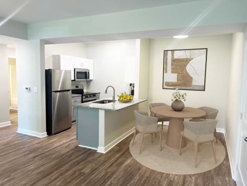 a kitchen and dining area with a stainless steel refrigerator