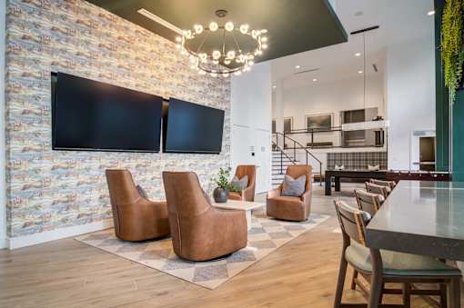 A modern living room with a stone wall and a television.