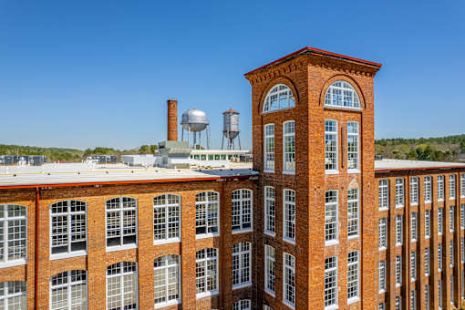 A red brick building with a water tower on top.