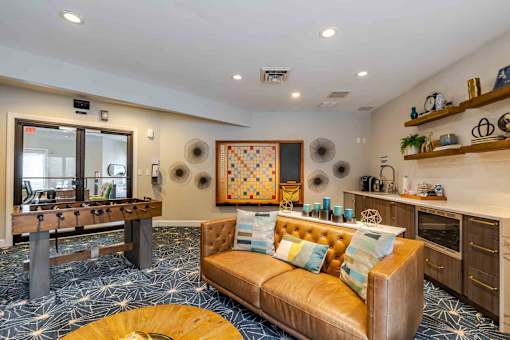 A living room with a brown couch and a wooden coffee table.
