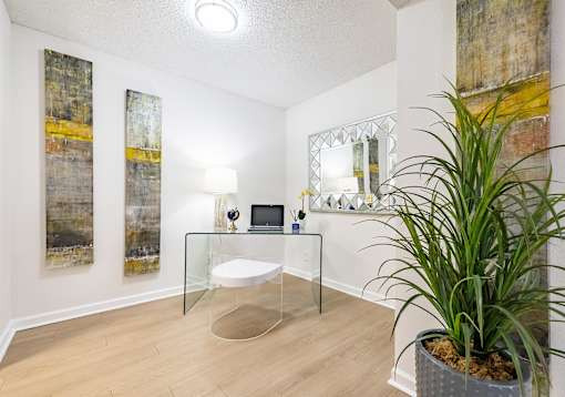 A room with a glass table, a mirror, and a potted plant at Waterview at Rocky Point, Tampa, FL