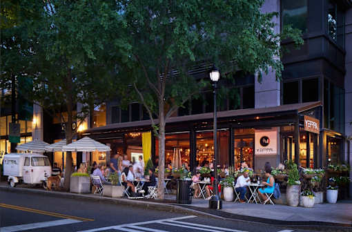 A restaurant with people dining outside at night.