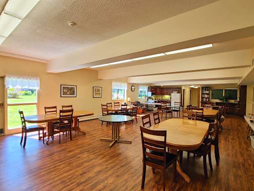 Country Park community room with tables for chatting and dining as well as adjascent full kitchen for community cooking.