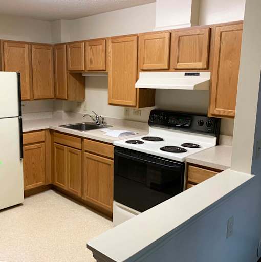 McKenzie House kitchen with refrigerator, stove and upper and lower cabinets
