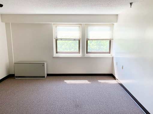 McKenzie House living room with carpeted floors and exterior window