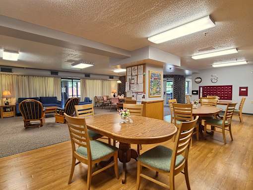 McKenzie House common room with seating area, community board and resident mailboxes