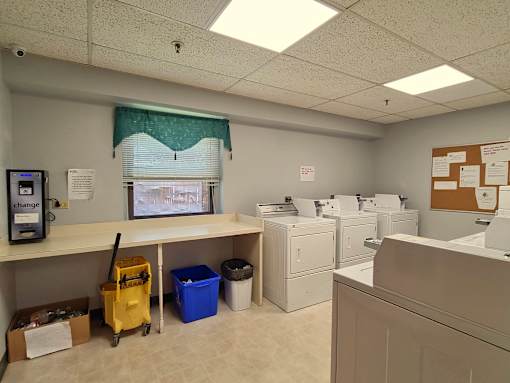 McKenzie House laundry room with coin operated washers and dryers