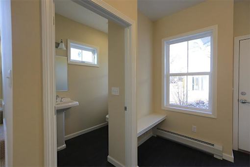Entryway to the aparment with first floor bathroom on the left