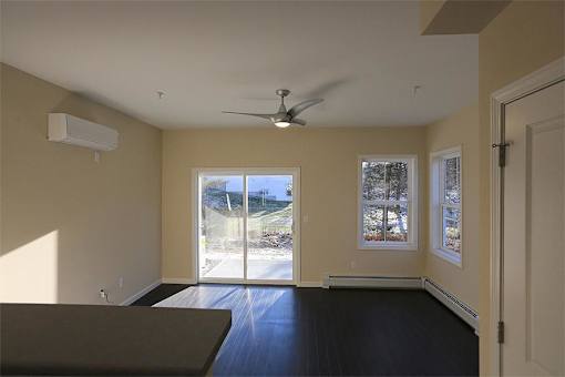 Rye Living room with wood floors and sliding doors to patio