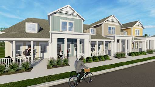 Row of houses with Person riding bicycle in front of it at Allier Heartwood, Richmond Hill, Georgia
