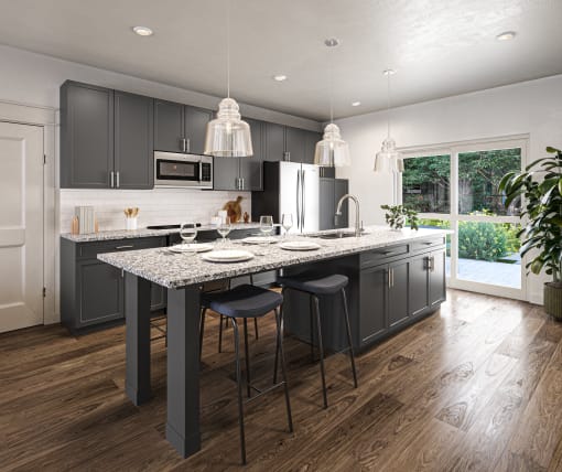 a kitchen with gray cabinets and a marble counter top