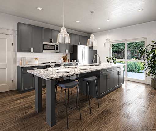 a kitchen with gray cabinets and a marble counter top