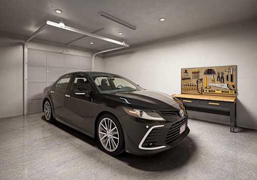 a black car parked in a garage next to a machine