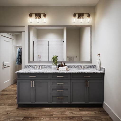a bathroom with a large mirror and a sink with granite counter tops