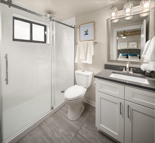 a bathroom with a toilet sink and shower