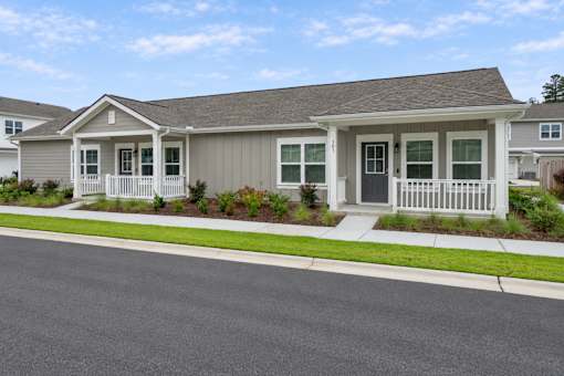 A house with a grey roof and white trim is shown.