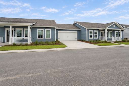 A row of houses with a driveway in front.