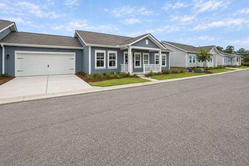 A row of houses with garages and driveways.