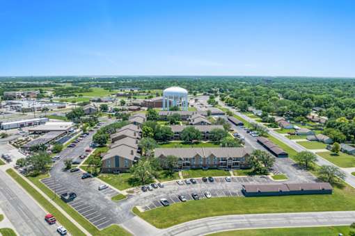 an aerial view of a city with buildings and a water tower