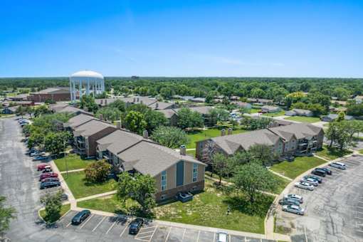 an aerial view of a neighborhood of houses with a water tower in the background