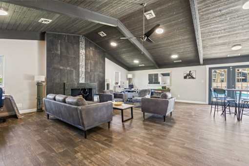 a living room with couches and chairs and a fireplace