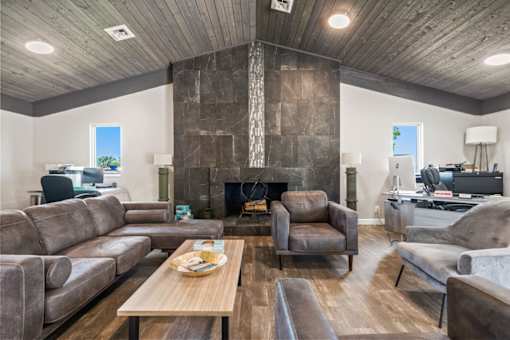 a living room with couches and chairs and a fireplace