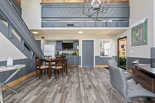 a living room and kitchen with a table and chairs