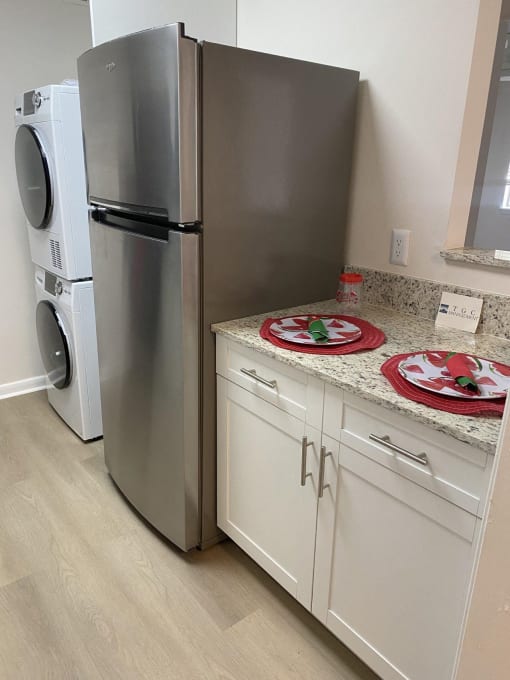 a kitchen with a counter and a refrigerator and a washing machine