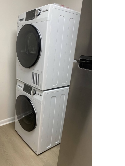 a front loading washer and dryer in a laundry room