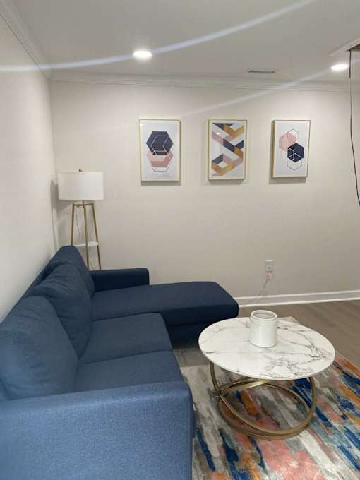 a living room with a blue couch and a coffee table