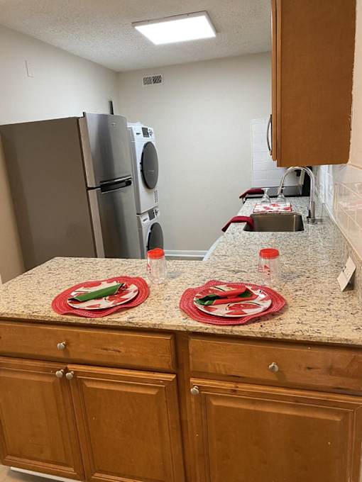 a kitchen with a counter with two plates on it and a refrigerator
