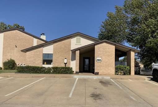A building with a parking lot in front of it.