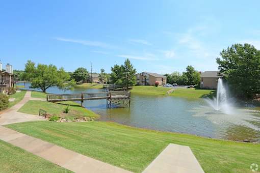 A park with a pond and a fountain.