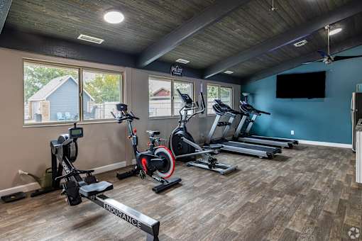 A spacious home gym with a variety of exercise equipment.