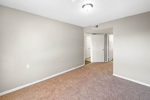 A room with carpeted floor and white walls.