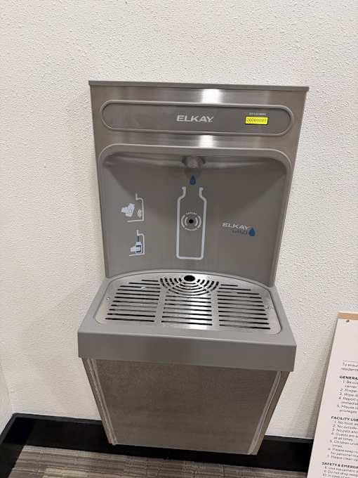 A gray water fountain with the word