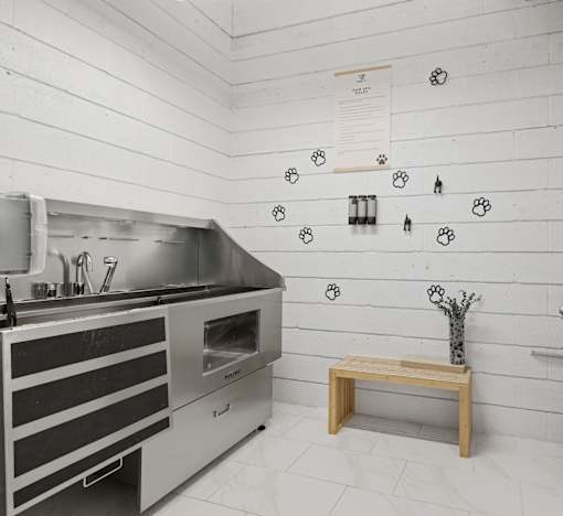 A kitchen with a stainless steel oven and a wooden bench.