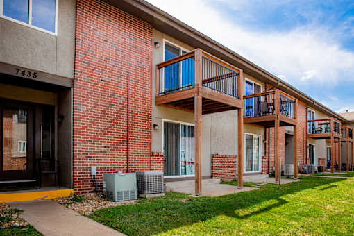 Apartment building with a balcony and air conditioning units.