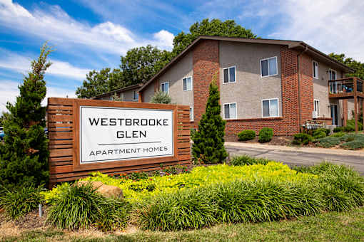 A sign for Westbrooke Glen Apartment Homes in front of a building.