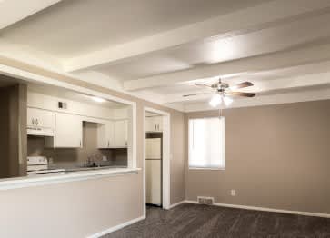 A room with a ceiling fan and a window.