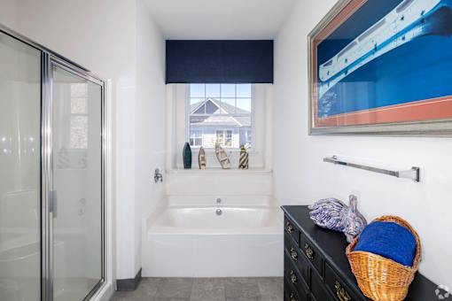Spacious primary bathroom with a large soaking tub and stall shower