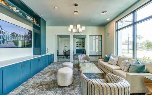 a blue and white living room with couches and a coffee table at Imperial Crossing Luxury Apartment Homes, Bonita Springs, Florida