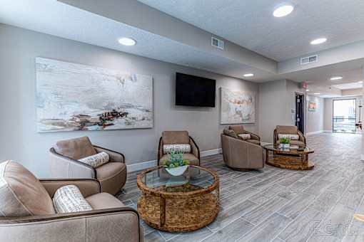 A living room with a large painting on the wall and a flat screen TV.at Tiffany Flats, Columbus, OH
