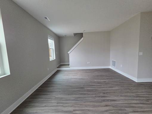 Townhome living area and stairs leading to second level at Flats at Sugar Run Apartments, Delaware, 43015