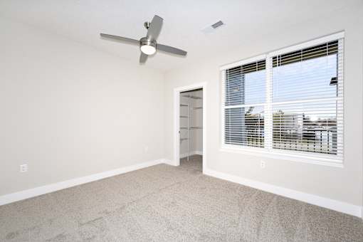 A room with a fan and a window with blinds.at Tiffany Flats, Columbus, 43231