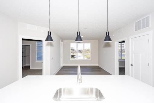 A modern kitchen with a large sink and pendant lights.at Tiffany Flats, Columbus